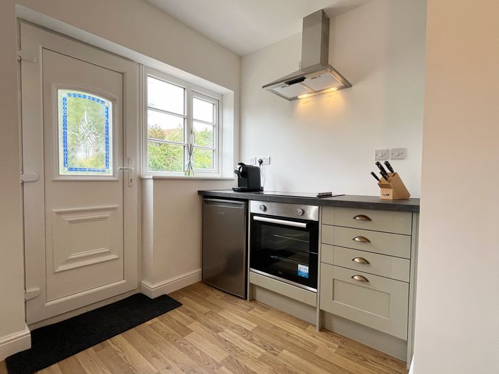Private entrance door with stained glass beside the kitchen